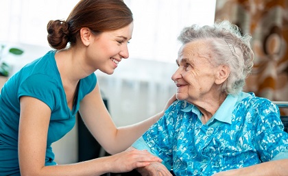A carer and a senior lady engaging in a light-hearted conversation