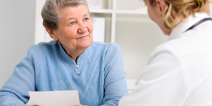 Elderly lady and a doctor, discussing her health